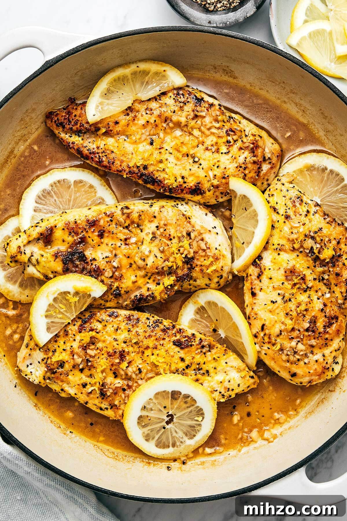Lemon pepper chicken in a pan.