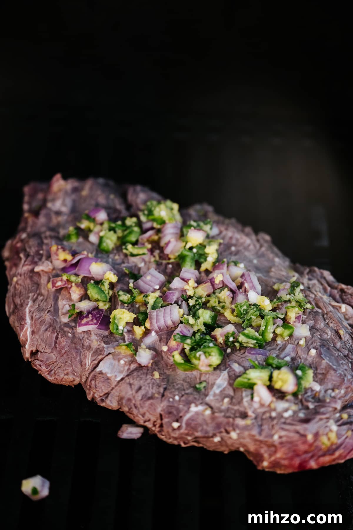 Grilled Carne Asada Steak Salad with Cilantro Lime Dressing 3 carne asada marinated and grilled flank steak on a black surface.