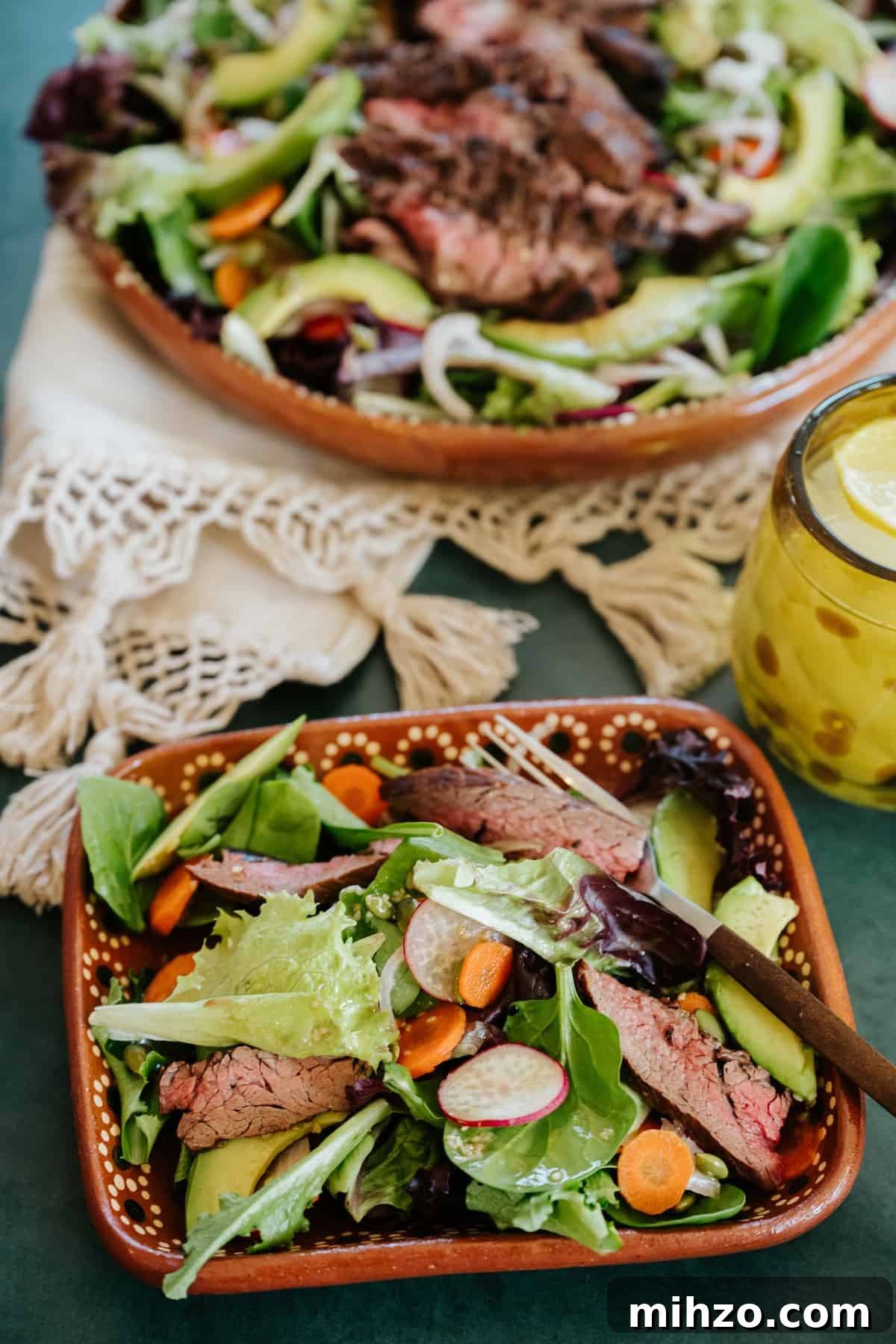 Grilled Carne Asada Steak Salad with Cilantro Lime Dressing 8 closeup shot of a square terracotta salad bowl filled with healthy carne asada steak salad.
