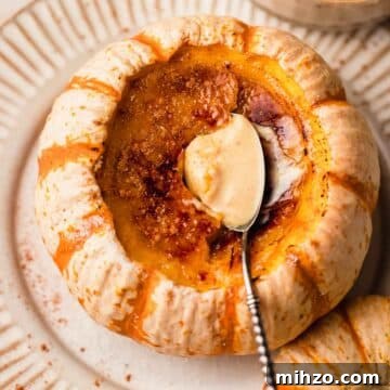 Pumpkin Crème Brûlée Recipe — Silky Fall Dessert Tutorial 17 creme brulee with spoon inside of a mini orange and white pumpkin