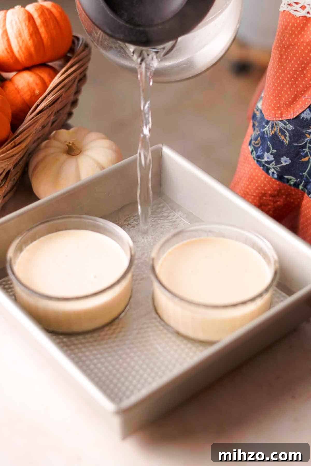 Pumpkin Crème Brûlée Recipe — Silky Fall Dessert Tutorial 7 pouring hot water into baking pan with ramekins