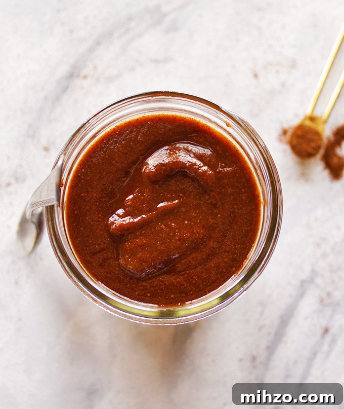 This gluten free red enchilada sauce is so easy to make - it only takes a few minutes and makes use of pantry staple ingredients. It's the perfect sauce for any enchilada recipe. Great for Cinco de Mayo or when you have a craving for good Mexican food! (Vegetarian/Vegan) | robustrecipes.com