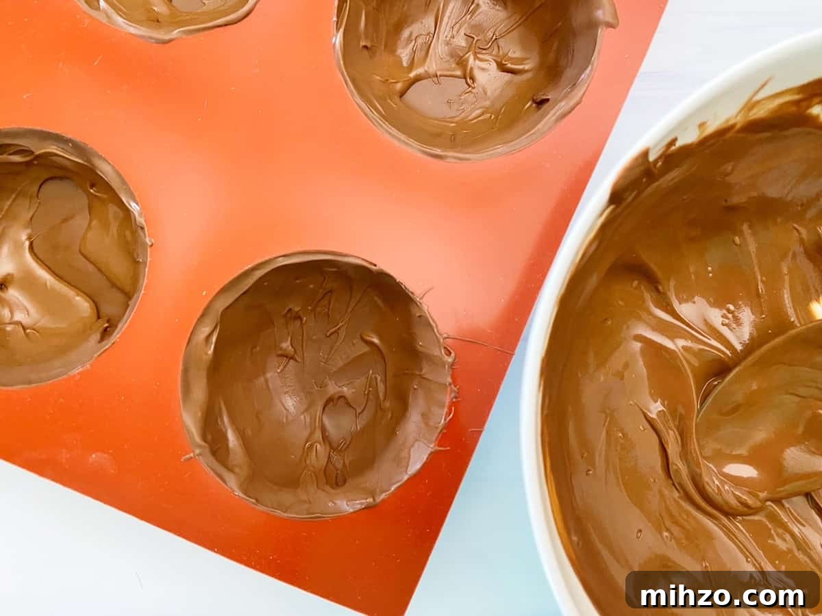 DIY Hot Cocoa Bombs with Free Printable Gift Tags 6 melted chocolate in cocoa bomb mold