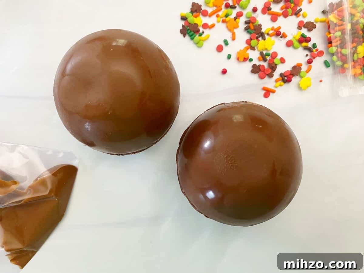 DIY Hot Cocoa Bombs with Free Printable Gift Tags 9 chocolate cocoa bombs with sprinkles to side and pastry bag with melted chocolate to side