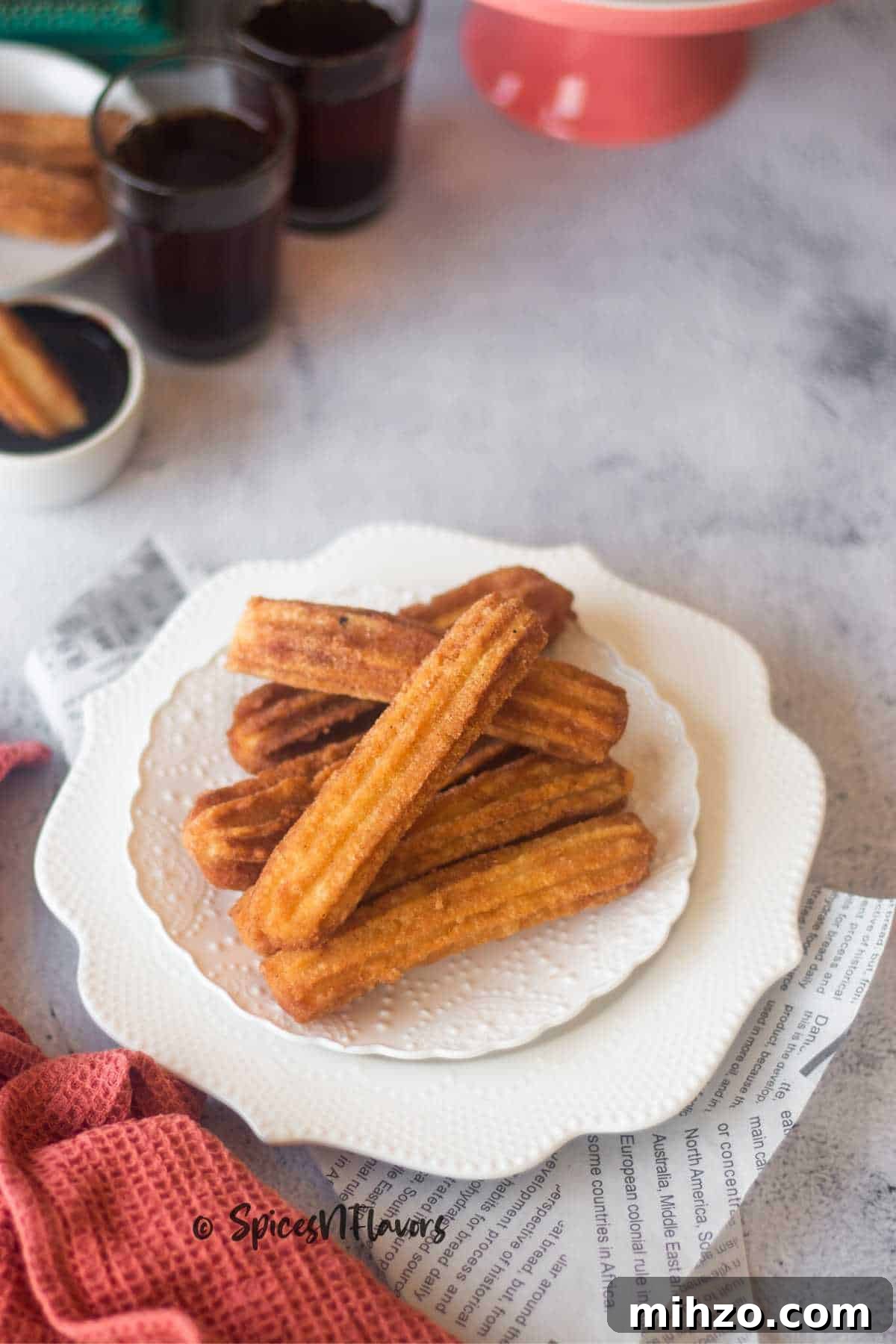 Crispy Eggless Churros Recipe: Step-by-Step Guide 4 cinnamon coated golden brown churros placed on a white plate