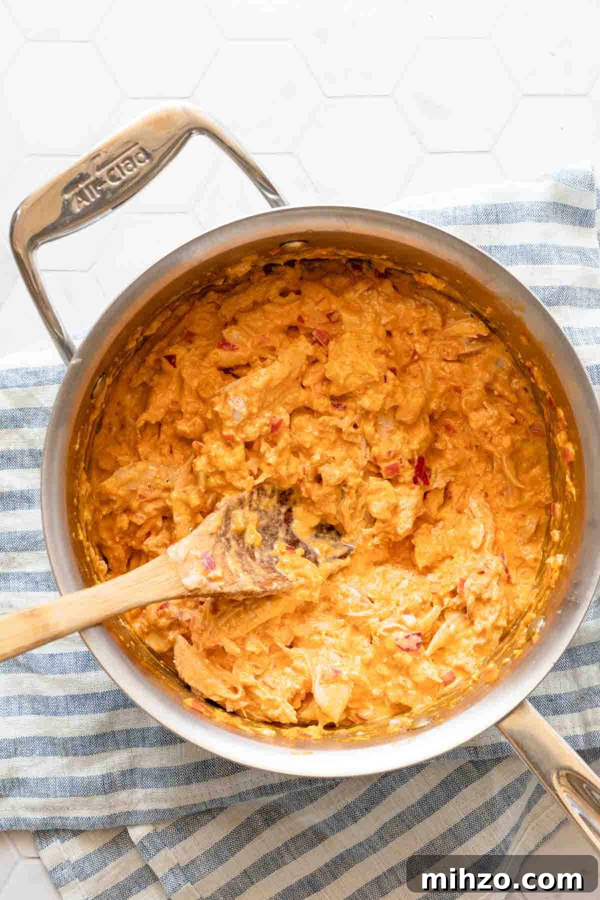 Greek yogurt buffalo chicken dip in saucepan before yogurt is added.