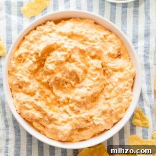 bowl of Greek yogurt buffalo chicken dip with chips on the side.