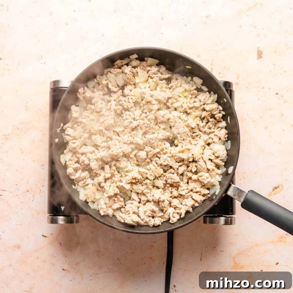 Ground Chicken Sloppy Joes with Tangy BBQ Sauce 4 ground chicken and onion cooking in a pan.