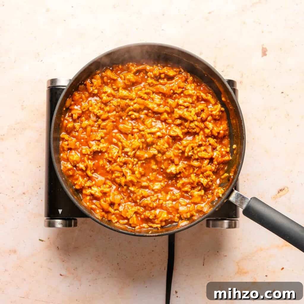 Ground Chicken Sloppy Joes with Tangy BBQ Sauce 6 simmering sloppy Joe mixture in pan.