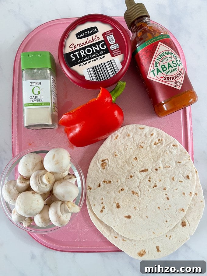 Cheesy Veggie Quesadillas with Roasted Peppers and Spinach 4 Ingredient's displayed on a pink chopping board.