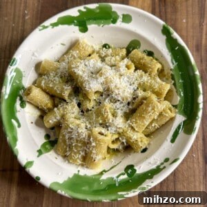 A plate of rigatoni pasta with pistachio pesto