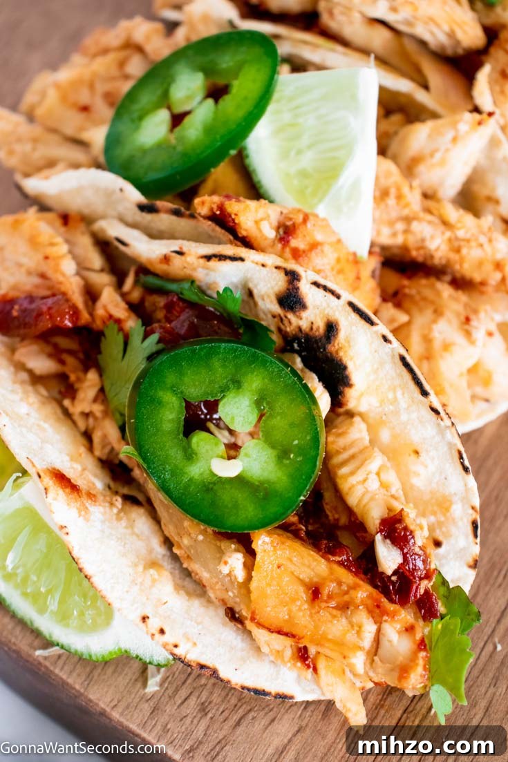Close-up of chicken carnitas in tortillas Instant Pot Chicken Carnitas wrapped in tortillas close up