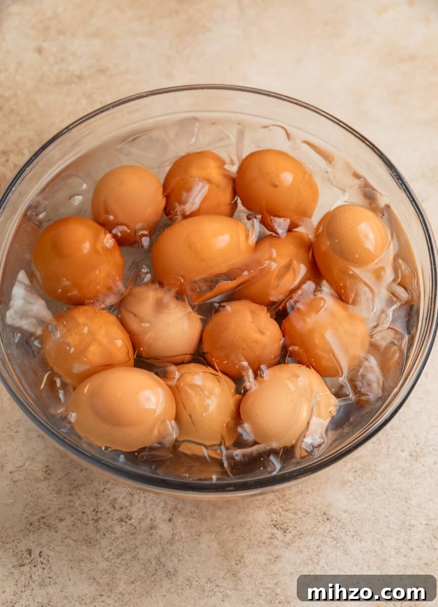Spicy Deviled Eggs with Sriracha and Smoked Paprika 5 Boiled eggs in ice bath after being hard boiled.