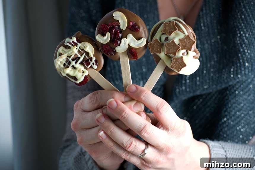 Chocolate Lollipops Recipe: Make Homemade Chocolate Pops 4 Someone holding up three different decorated chocolate lollipops