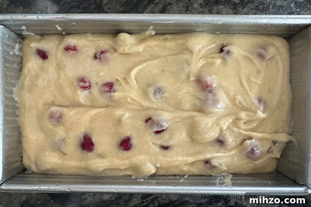 Gluten-Free Cranberry Pound Cake with Dairy-Free Option 7 The cake batter in a greased loaf pan.