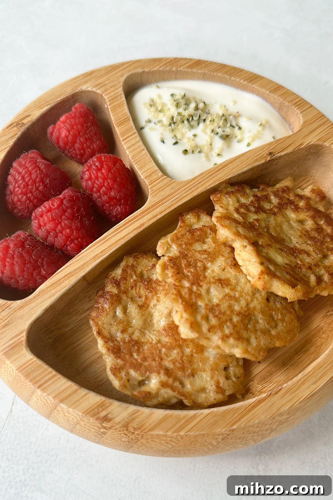 Cinnamon apple fritters served with raspberries and yogurt.