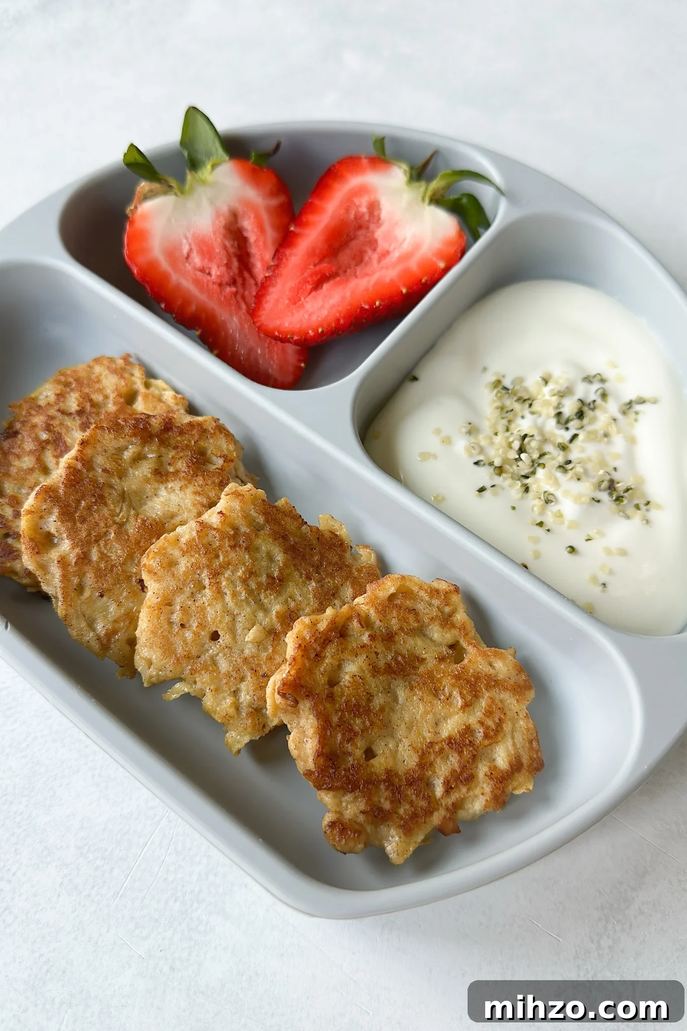 Cinnamon apple fritters served with strawberries and yogurt.