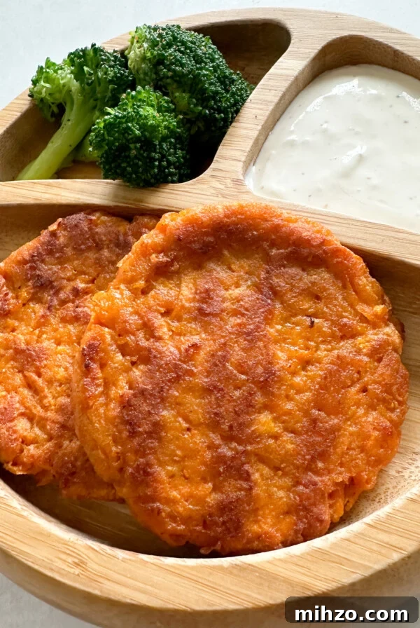 Sweet potato fritters served with broccoli and a dip.