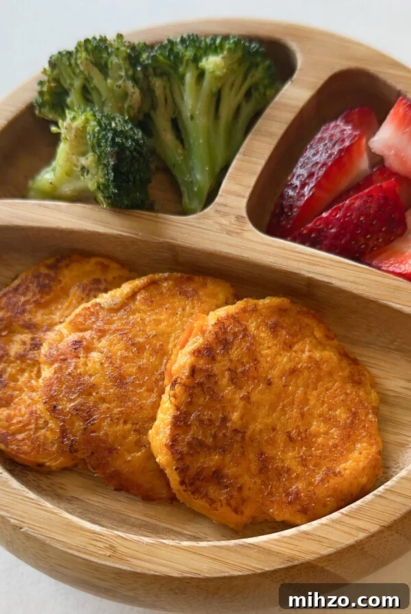 Cheesy carrot fritters served with strawberries and broccoli.