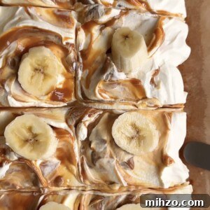 sliced squares of banana bread bars with swirled caramel icing on top and banana slices